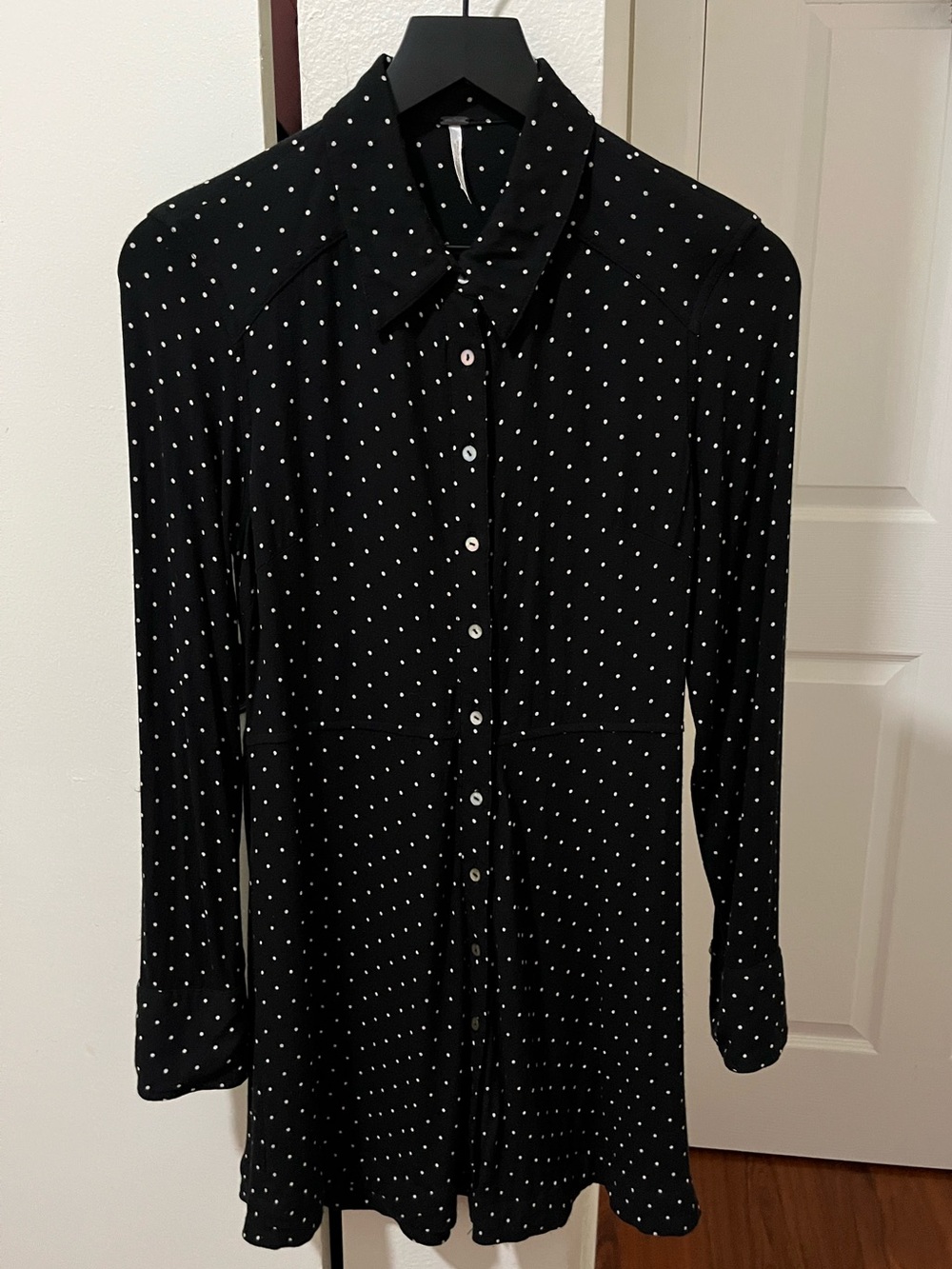Free People This Town Shirt Dress in a black and white polka dot pattern.